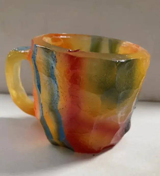 “Colorful earth-tone resin mug showing mineral crystal pattern”